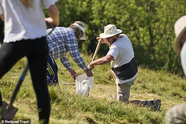 Volunteers and staff restore 180-foot Cerne Abbas Giant with 17 tonnes of chalk.